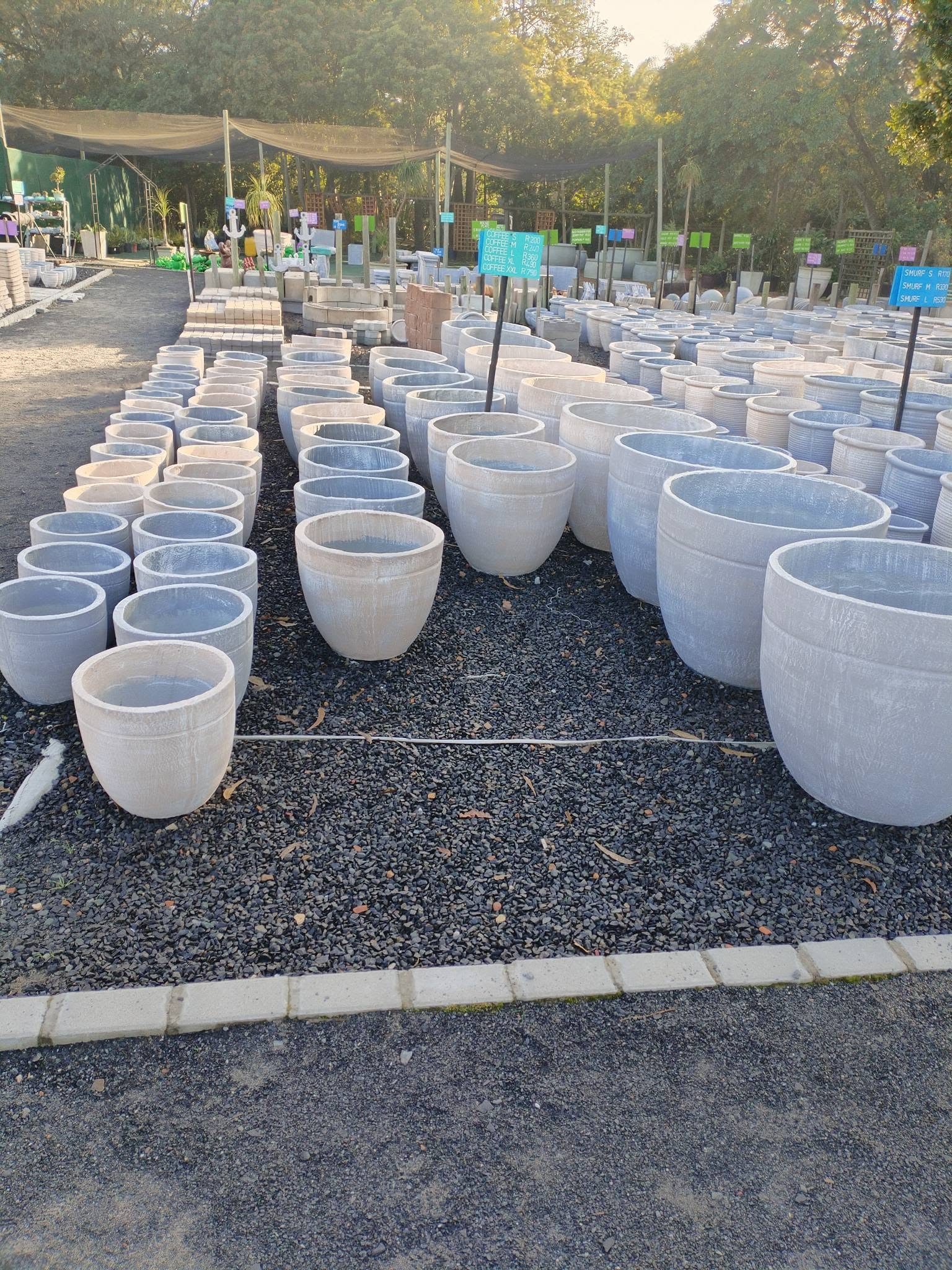 Rows of concrete garden pots at Am Flower Power