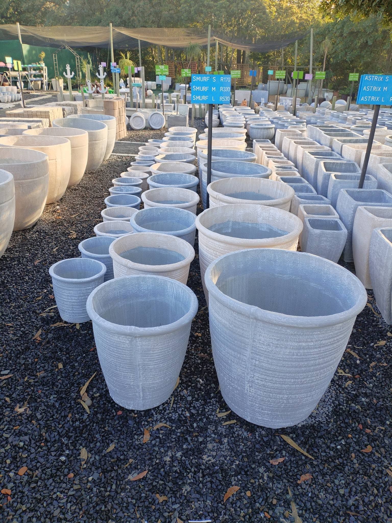 Rows of round concrete garden pots